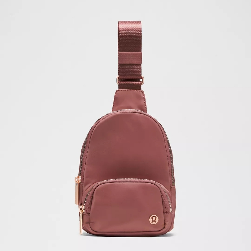 lululemon athletica rose dust sling bag with rose gold accents